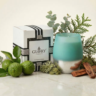 Earth’s Embrace Feng Shui earth element luxury candle in turquoise-to-silver ombré matte glass styled with bergamot, cedar, moss and GLORY STRENGTH gift box