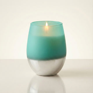 Earth’s Embrace Feng Shui earth element luxury candle lit with glowing flame in turquoise-to-silver ombré matte glass