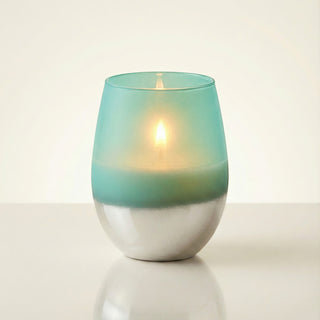 Earth’s Embrace Feng Shui earth element luxury candle burning with warm golden flame in turquoise-to-silver ombré glass