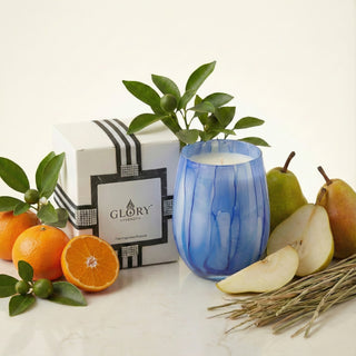 Azure Coastal Bliss Feng Shui water element luxury candle in blue marbled glass styled with fresh clementine, pears, sea grass and GLORY STRENGTH gift box